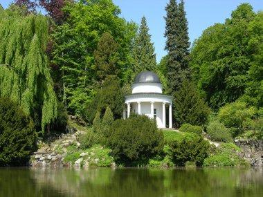 Ancient pavilion in a magnificent park scenery clipart