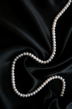 White pearls on the black velvet clipart