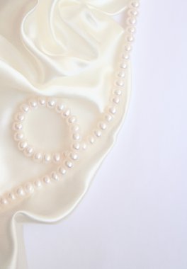 White pearls on the white silk clipart