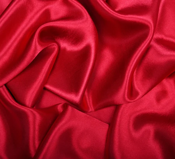Гладкий элегантный красный шелк в качестве фона — стоковое фото