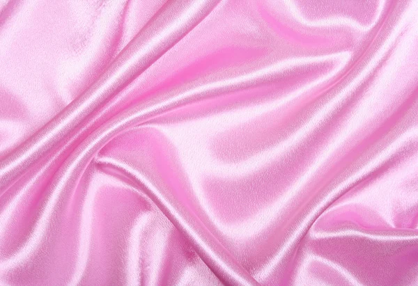 Гладкий элегантный розовый шелк в качестве фона — стоковое фото
