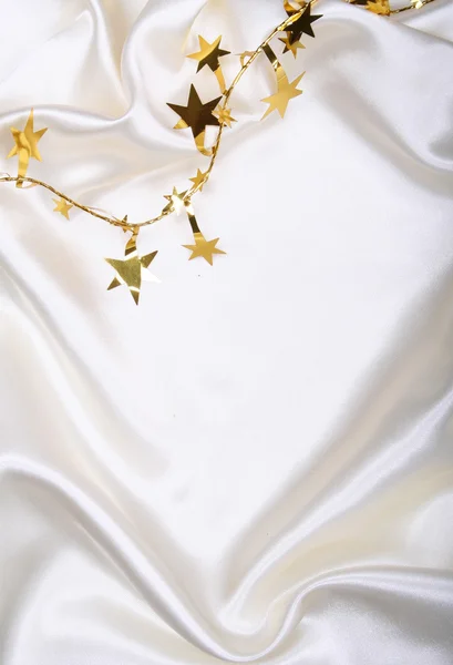 stock image Golden stars and spangles on white silk