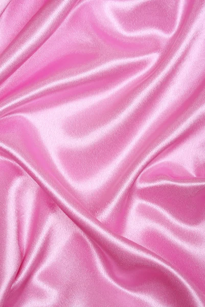 Гладкий элегантный розовый шелк в качестве фона — стоковое фото