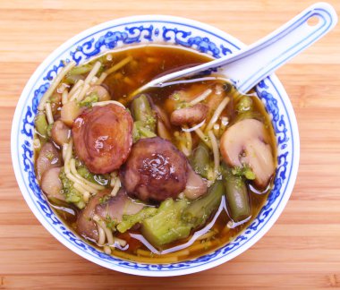 Vegetarian chinese soup with noodles and mushrooms clipart