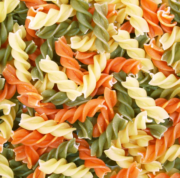 Ungekochte Italienische Pasta Dreifarbige Spiralen Als Hintergrund — Stockfoto
