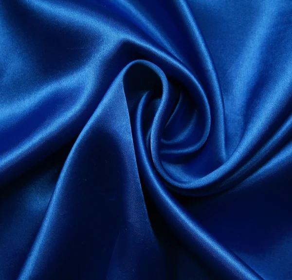 滑らかなエレガントな青絹は背景として使用することができます — ストック写真