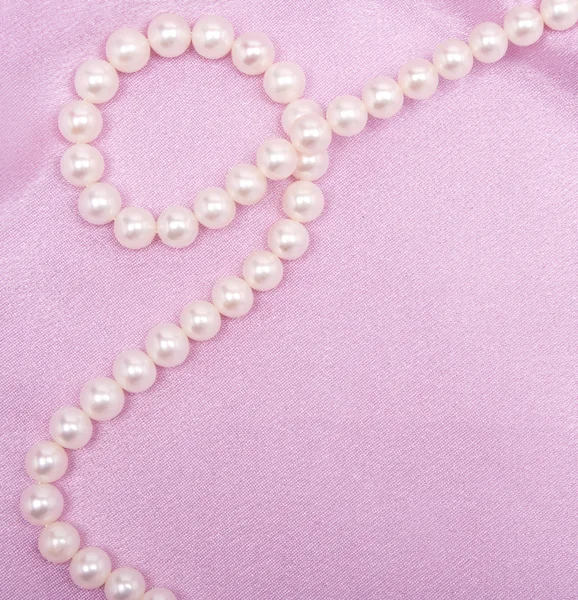 Smooth elegant pink silk with pearls as wedding background — Stock Photo, Image