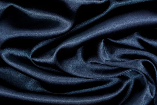 Гладкий элегантный черный шелк в качестве фона — стоковое фото
