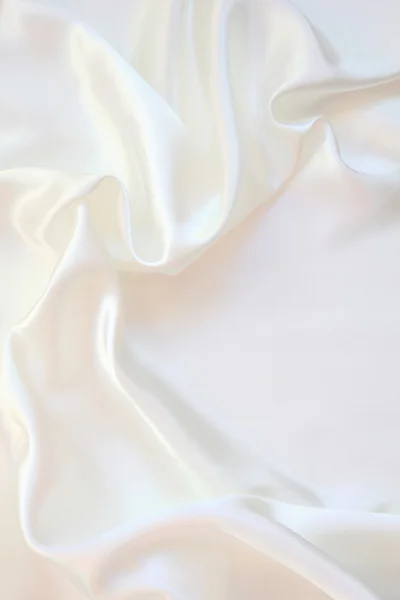 滑らかなエレガントな白い絹は背景として使用することができます — ストック写真