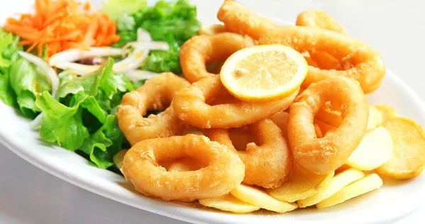 stock image Deep batter fried squid rings calamari with green salad