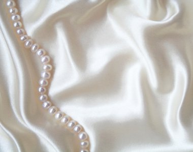 Smooth elegant white silk with pearls as wedding background clipart