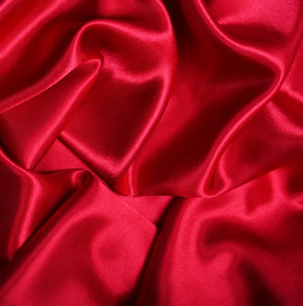 滑らかなエレガントな赤い絹は背景として使うことができます — ストック写真