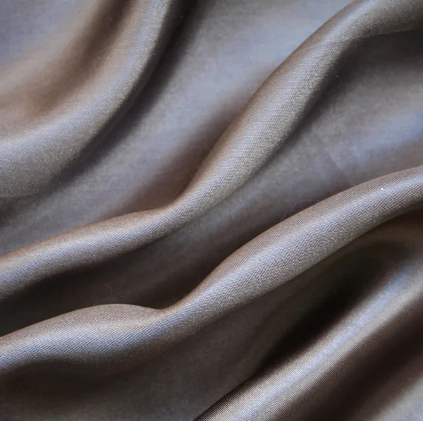 Гладкий элегантный серый шелк в качестве фона — стоковое фото