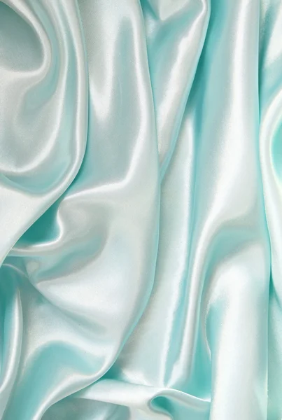 Гладкий элегантный синий шелк можно использовать в качестве фона — стоковое фото