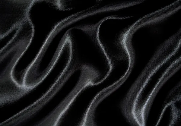 Soepele elegante zwarte zijde als achtergrond — Stockfoto