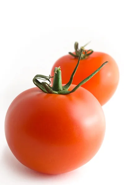 Two tomatoes, on white background, vertically. — Stock Photo, Image