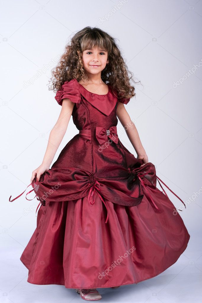 Beautiful little girl dancing in wine red dress