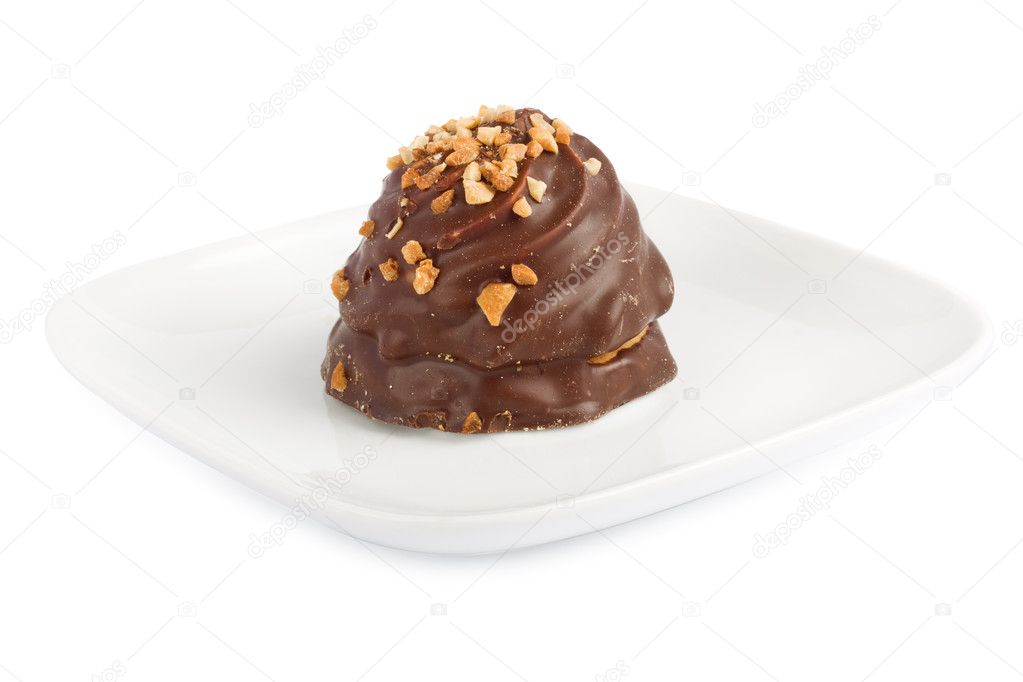 Chocolate candy sprinkled with nuts on white isolated background