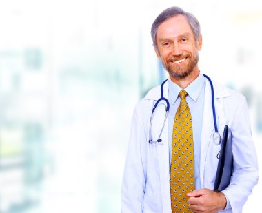 Closeup portrait of a happy senior doctor with stethoscope clipart