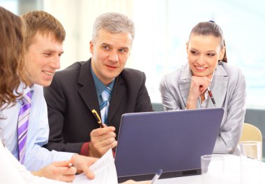 Small business team in the office in front of a whiteboard discussing a pro clipart