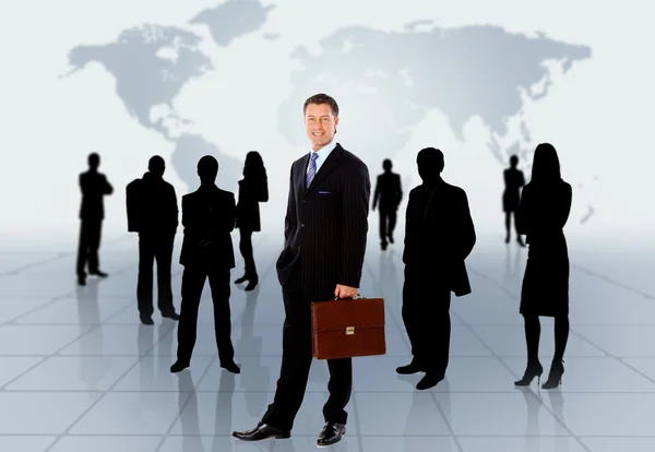 Businessman standing in front of an earth map Stock Image