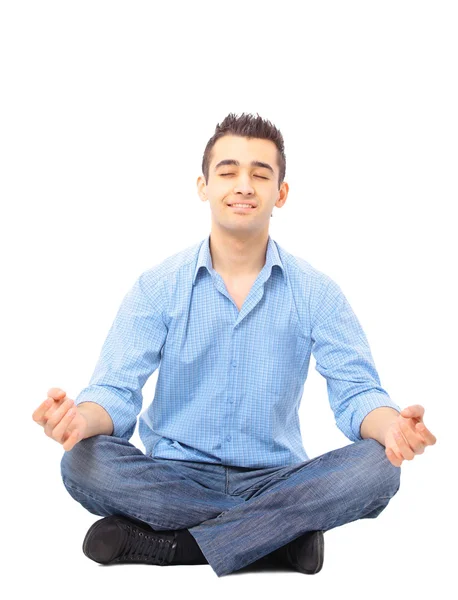 Portrait of young man meditating in a lotus position — Stock Photo, Image