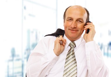 Mature executive man giving explanations and talking at phone mobile clipart