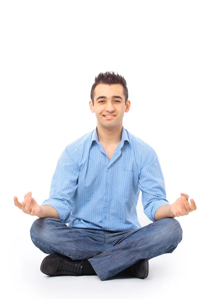 Portrait of young man meditating in a lotus position — Stock Photo, Image