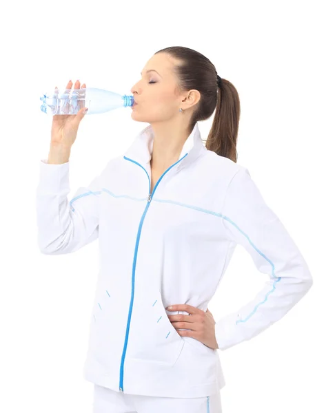 Donna in abbigliamento sportivo acqua potabile, isolata su bianco — Foto Stock