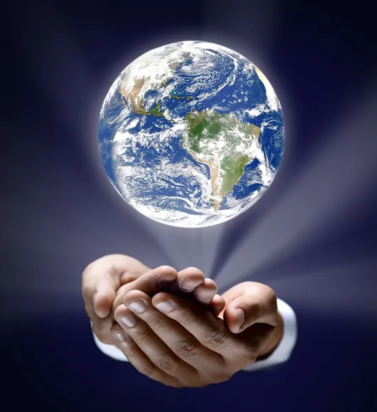 Man holding a glowing earth globe in his hands Stock Photo