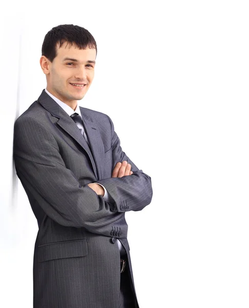 Businessman standing against a blank gray wall. — Stock Photo, Image