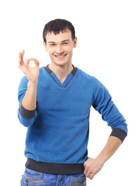 Portret uśmiechający się przystojny młody mężczyzna gestykulacji ok znak przed biały ba — Zdjęcie stockowe