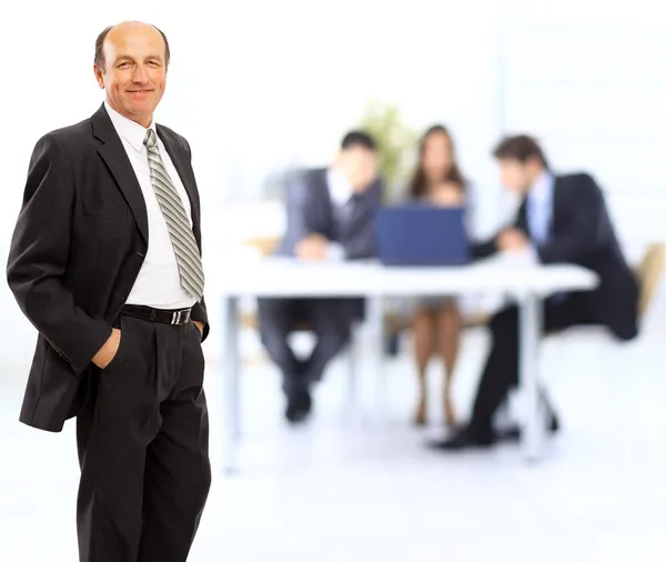 Портрет уверенного взрослого бизнесмена, стоящего в офисе - в помещении — стоковое фото