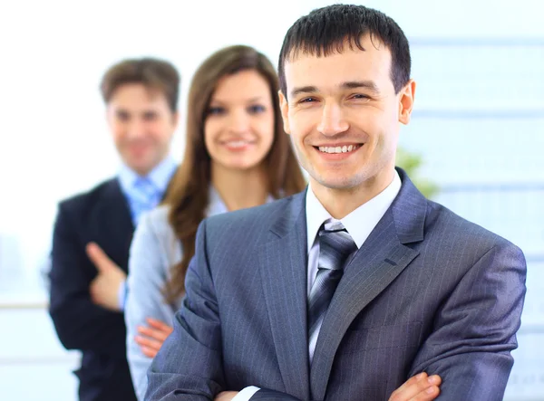 Portrait of a successful businessman standing with arms crossed and colleag — Stock Photo, Image