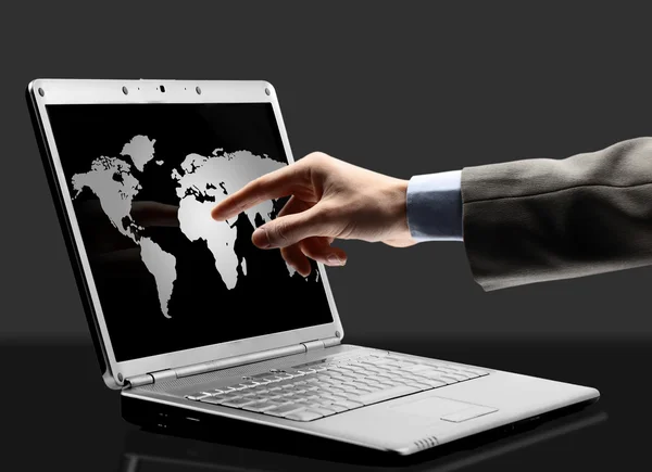 Schwarzer Laptop mit Umrissen der Welt auf dem Bildschirm — Stockfoto
