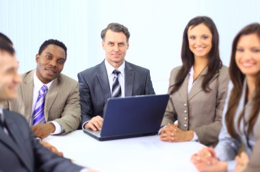 Group of happy business colleague in a meeting together at office clipart