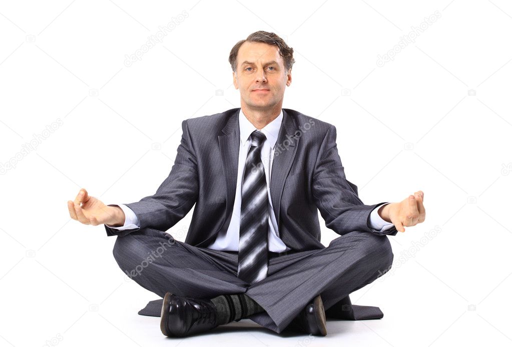 Relaxed businessman meditating isolated on white