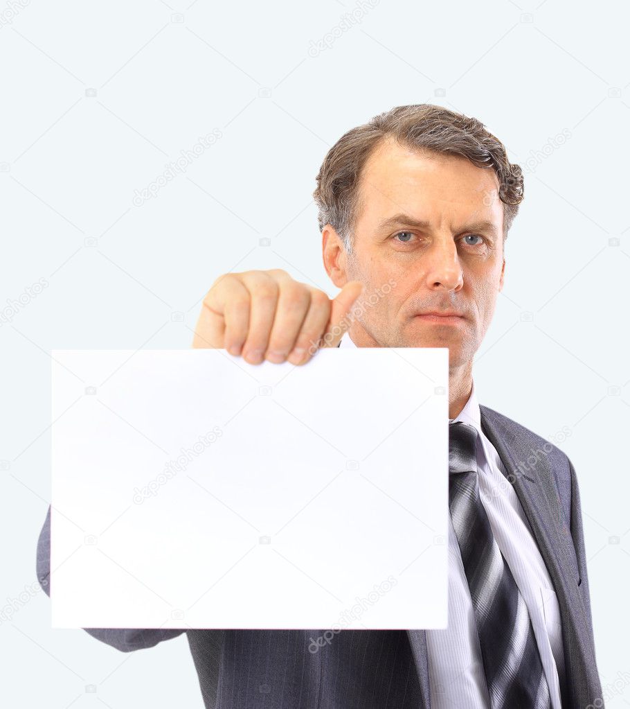 Portrait of handsome mature bussiness male executive pointing at empty whit