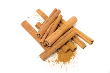 A pile of cinnamon sticks and ground cinnamon isolated on a white background clipart