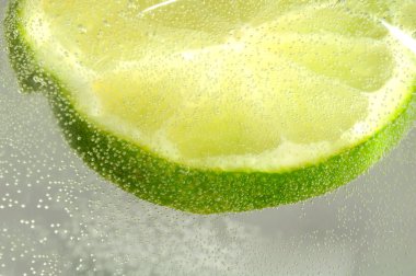 Slice of Lime in Water with Bubbles