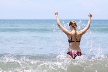 seksi kadın plajda bikini giyiyor