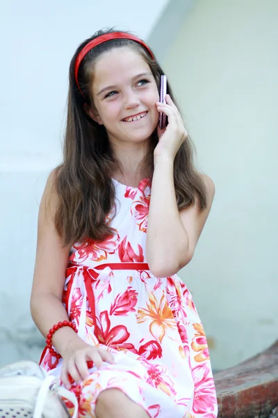 Little girl talks by mobile phone — Stock Photo, Image