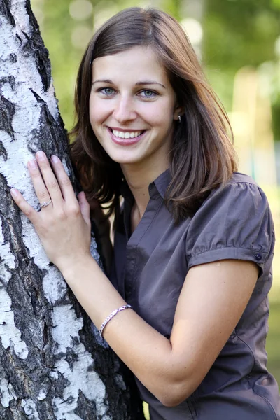 Russian beauty - the happy girl at a white birch — Stock Photo, Image