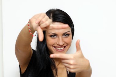 Woman making photografing sign standing indoors clipart