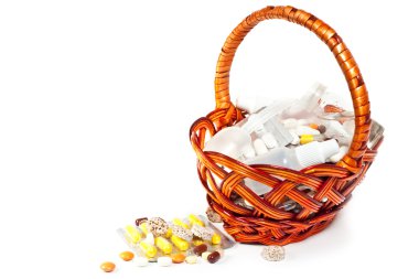 Pills and vitamins in brown basket clipart