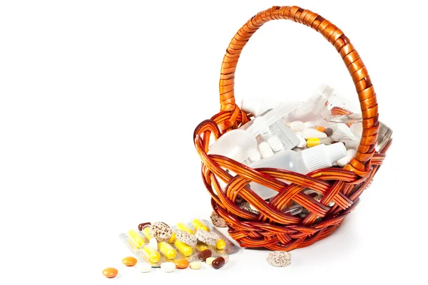 Pills and vitamins in brown basket — Stock Photo, Image