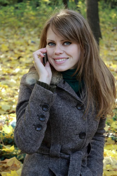 Autumn using a mobile phone — Stock Photo, Image
