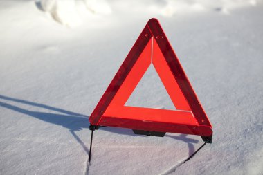 Warning triangle on snow serface clipart
