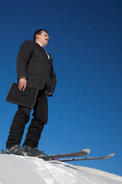 Man in business sute on ski — Stock Photo, Image