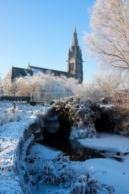 Church on the channel at winter clipart